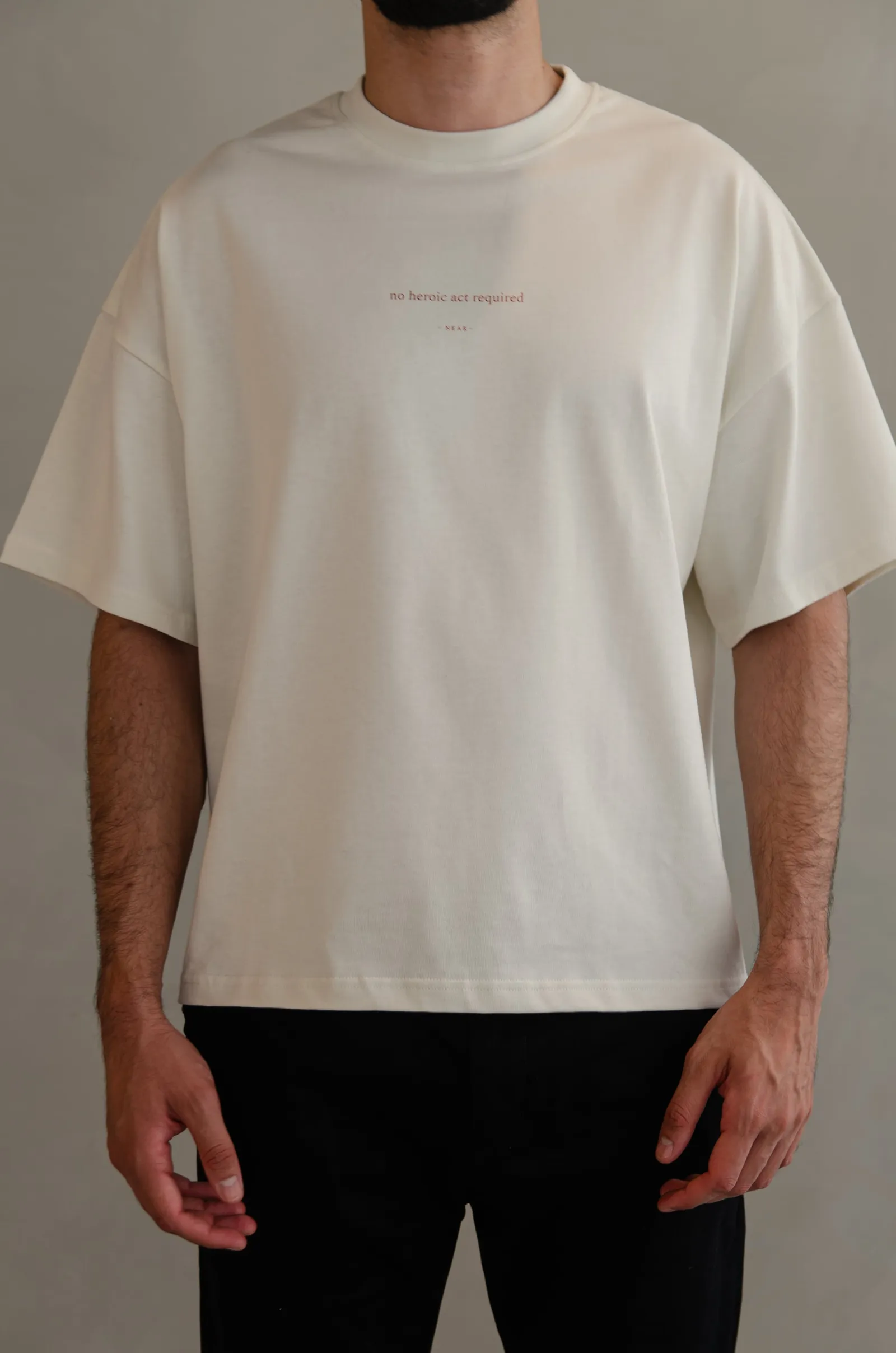 NEAR heavyweight vintage-white tee printed “no heroic act required” — photo 1 of 11.
