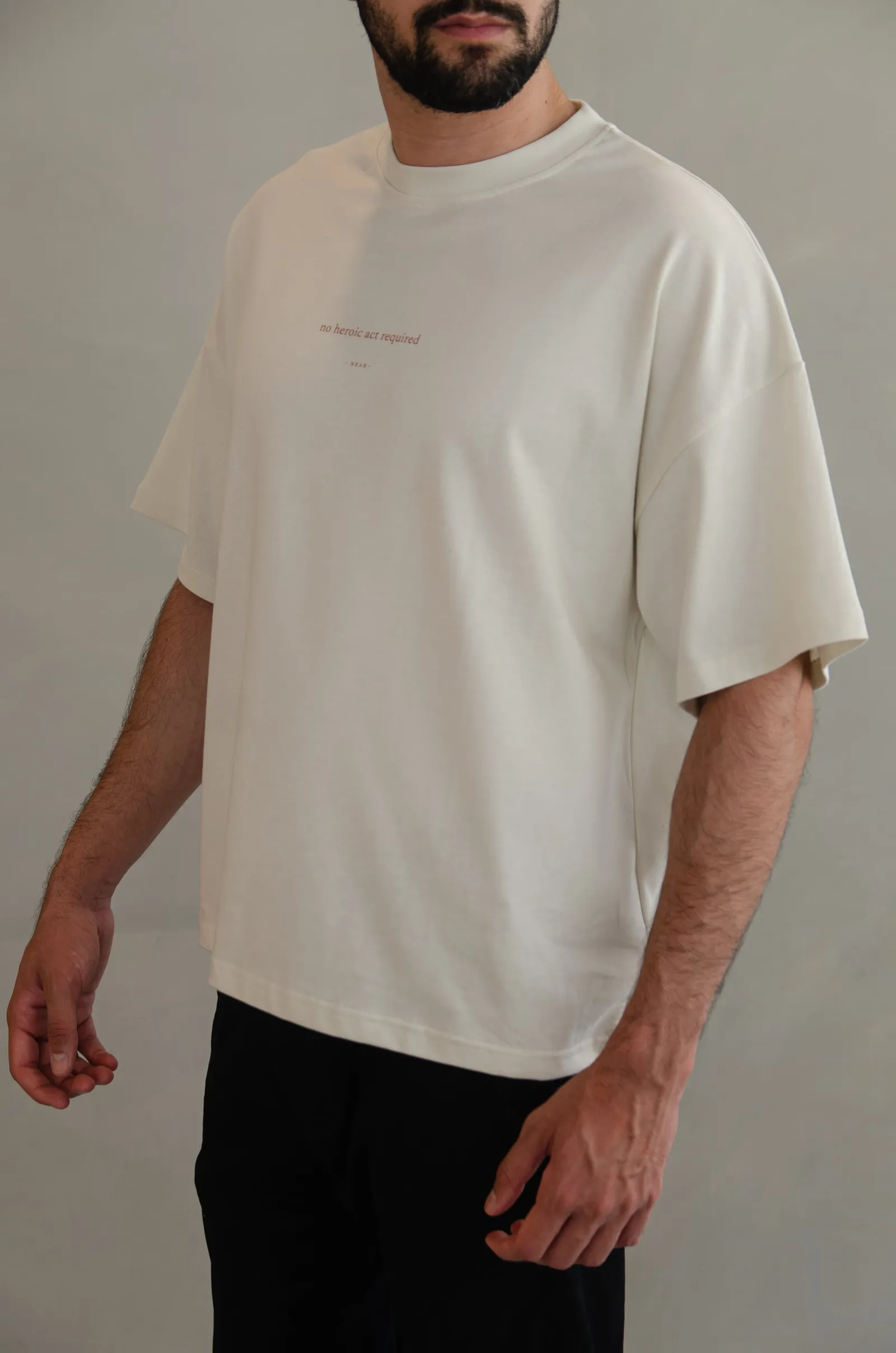 NEAR heavyweight vintage-white tee printed “no heroic act required” — photo 3 of 11.