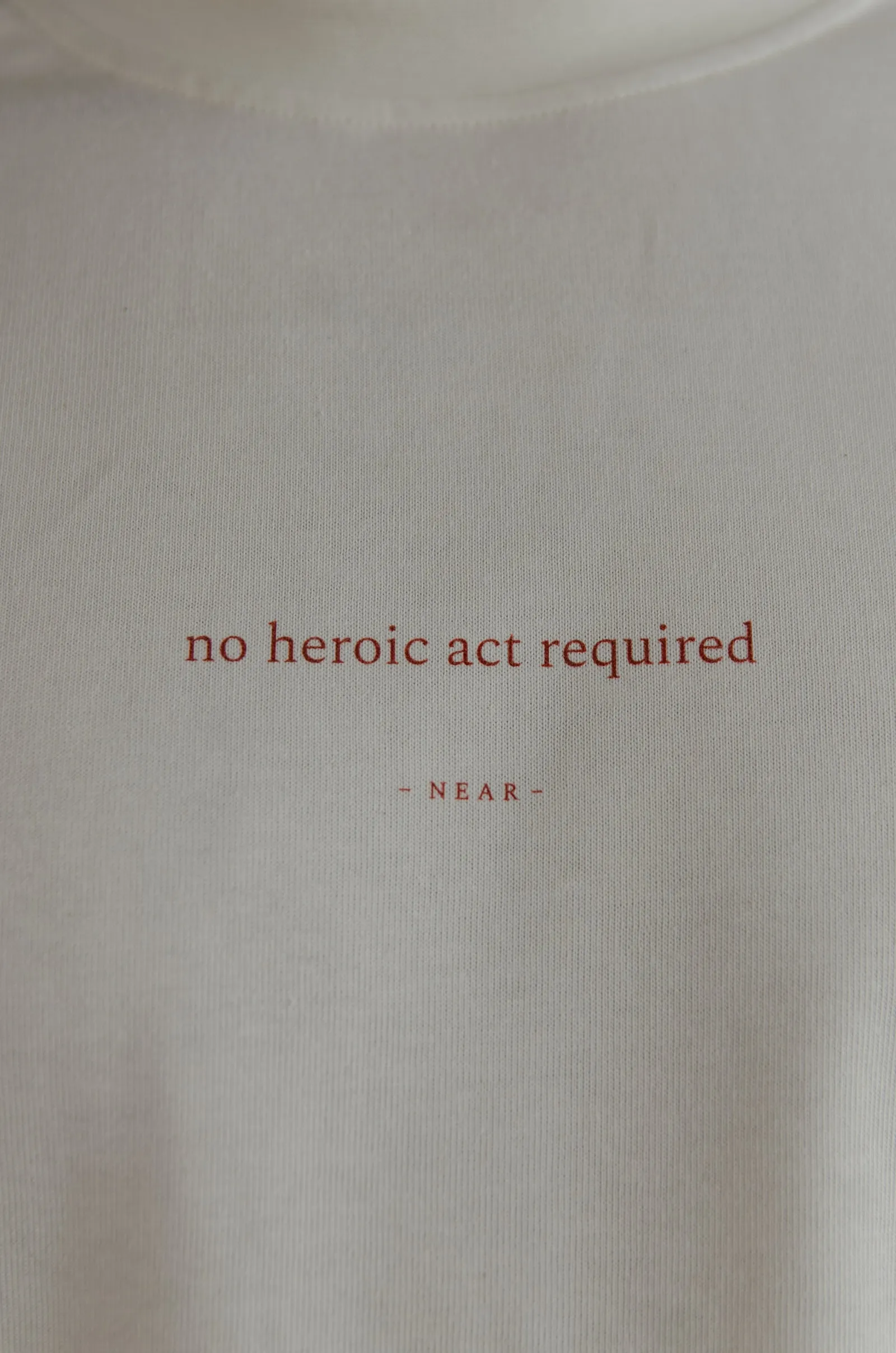 NEAR heavyweight vintage-white tee printed “no heroic act required” — photo 5 of 11.